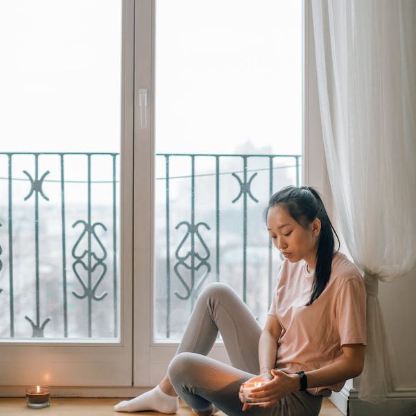 A serene setting with a yoga mat, candles, and soft lighting, ideal for evening practice.