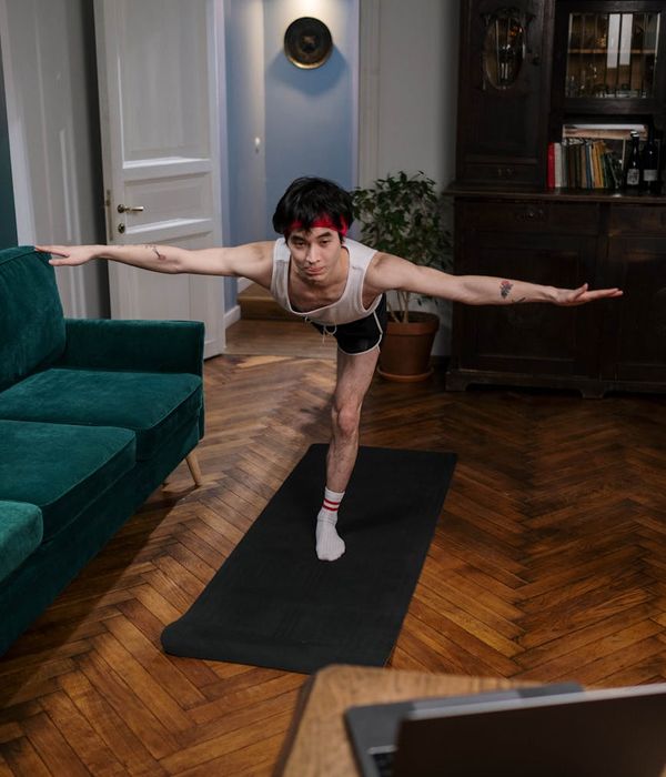 Person holding a challenging yoga pose, demonstrating strength and focus.